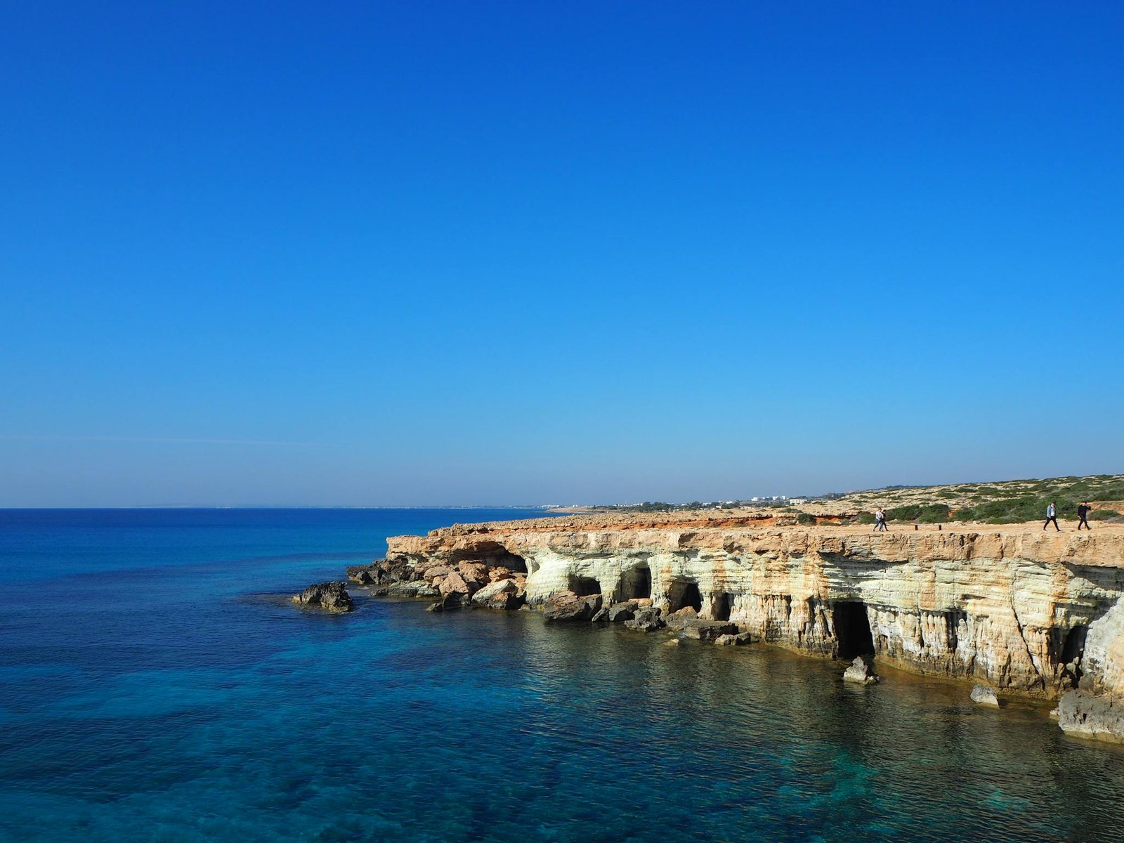 Stunning view of sea caves and clear blue waters in Cyprus along the coast.